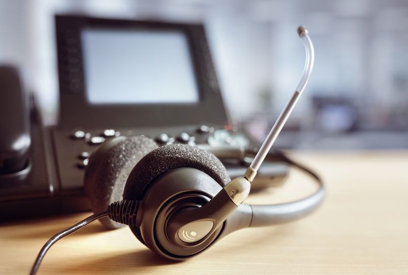 Headset headphones and telephone in call center